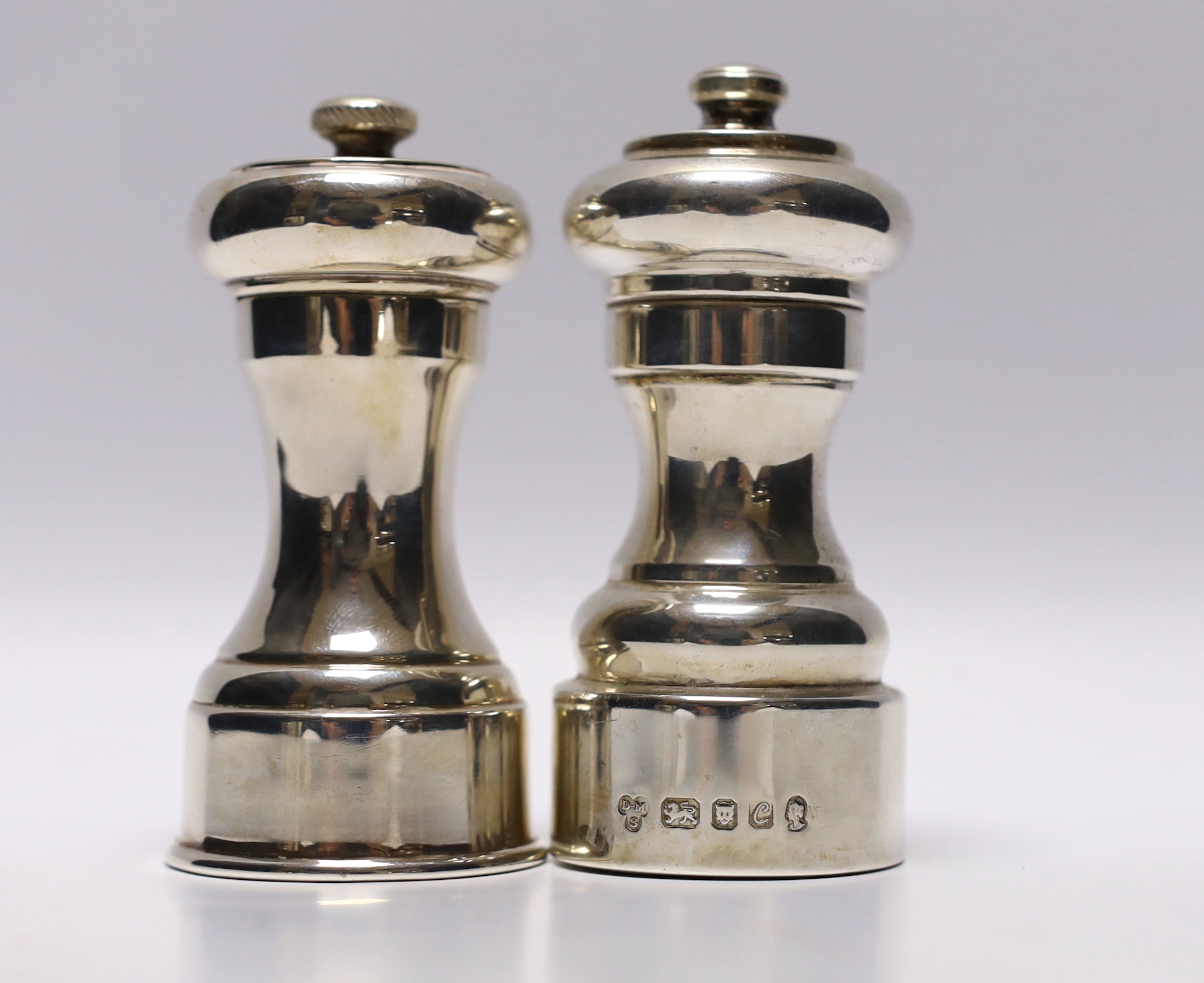 A 1970's silver mounted pepper mill, Da-Mar Silverware, London, 1977, 10.6cm, together with a silver plated pepper mill.